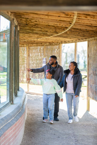 Family pointing at window outside